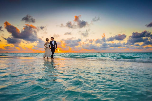 a couple walking near a pool