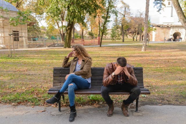 a couple sitting in a bench