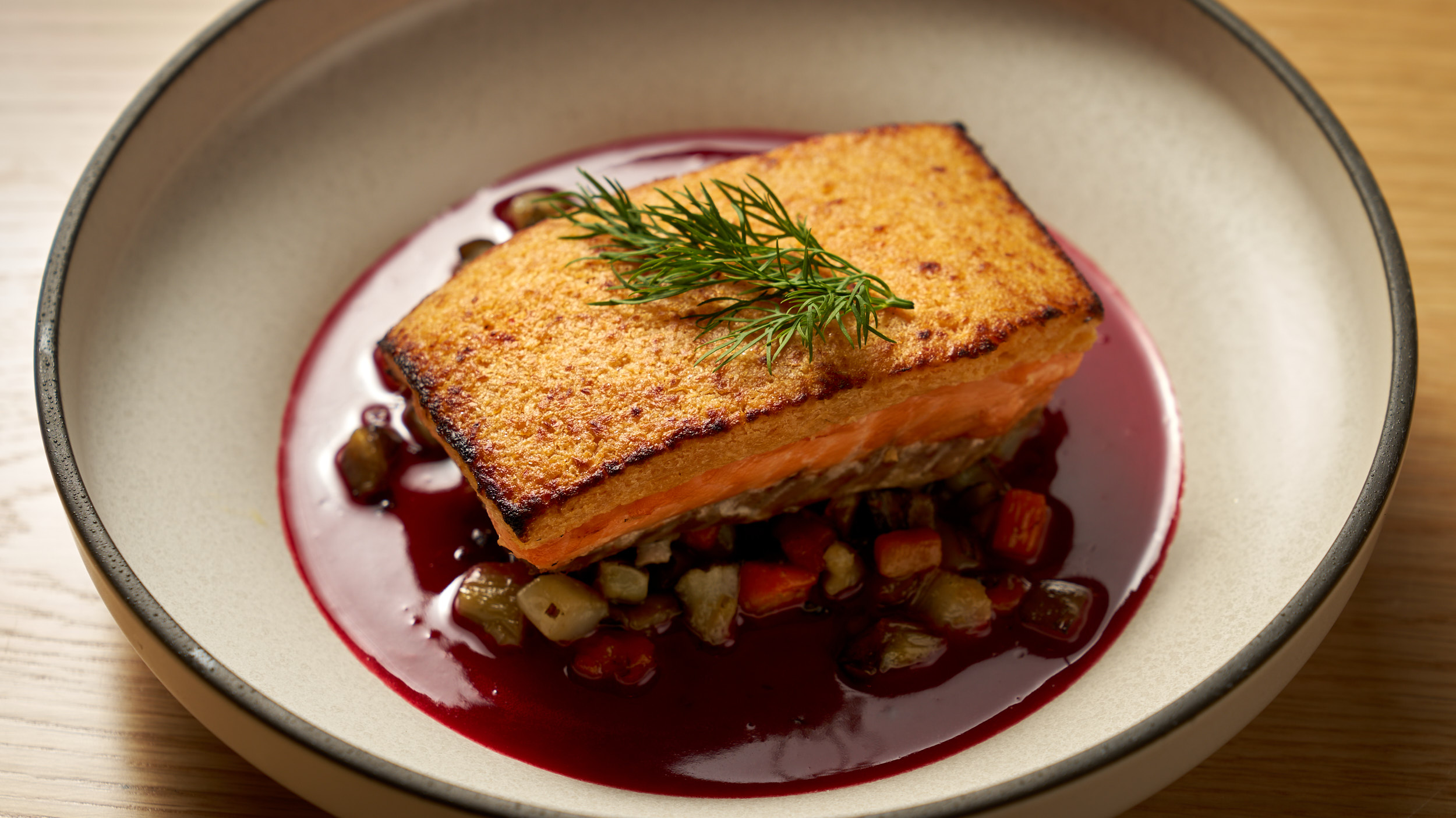 a plate of food with a slice of cake on a table