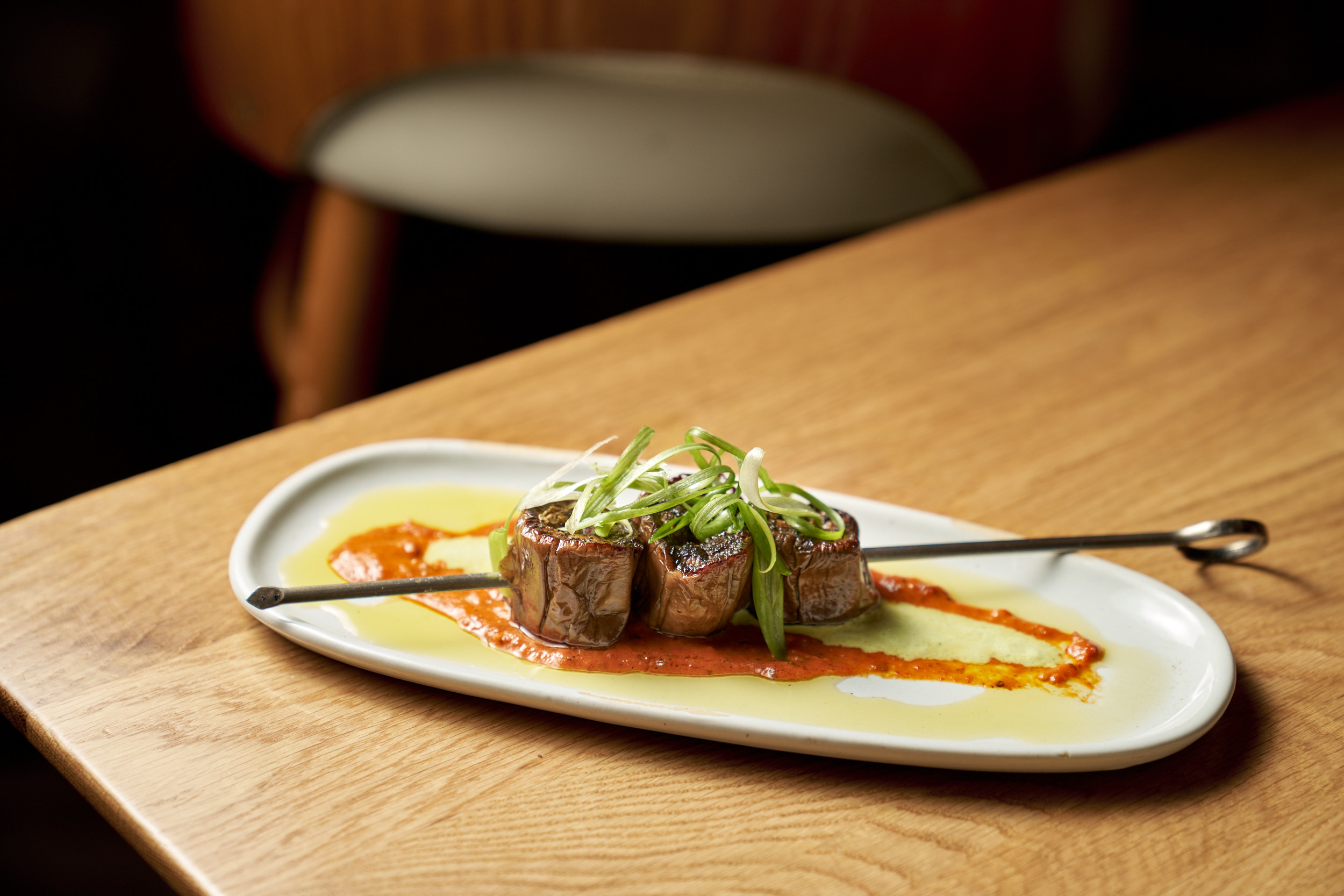 a plate of food sitting on top of a wooden table