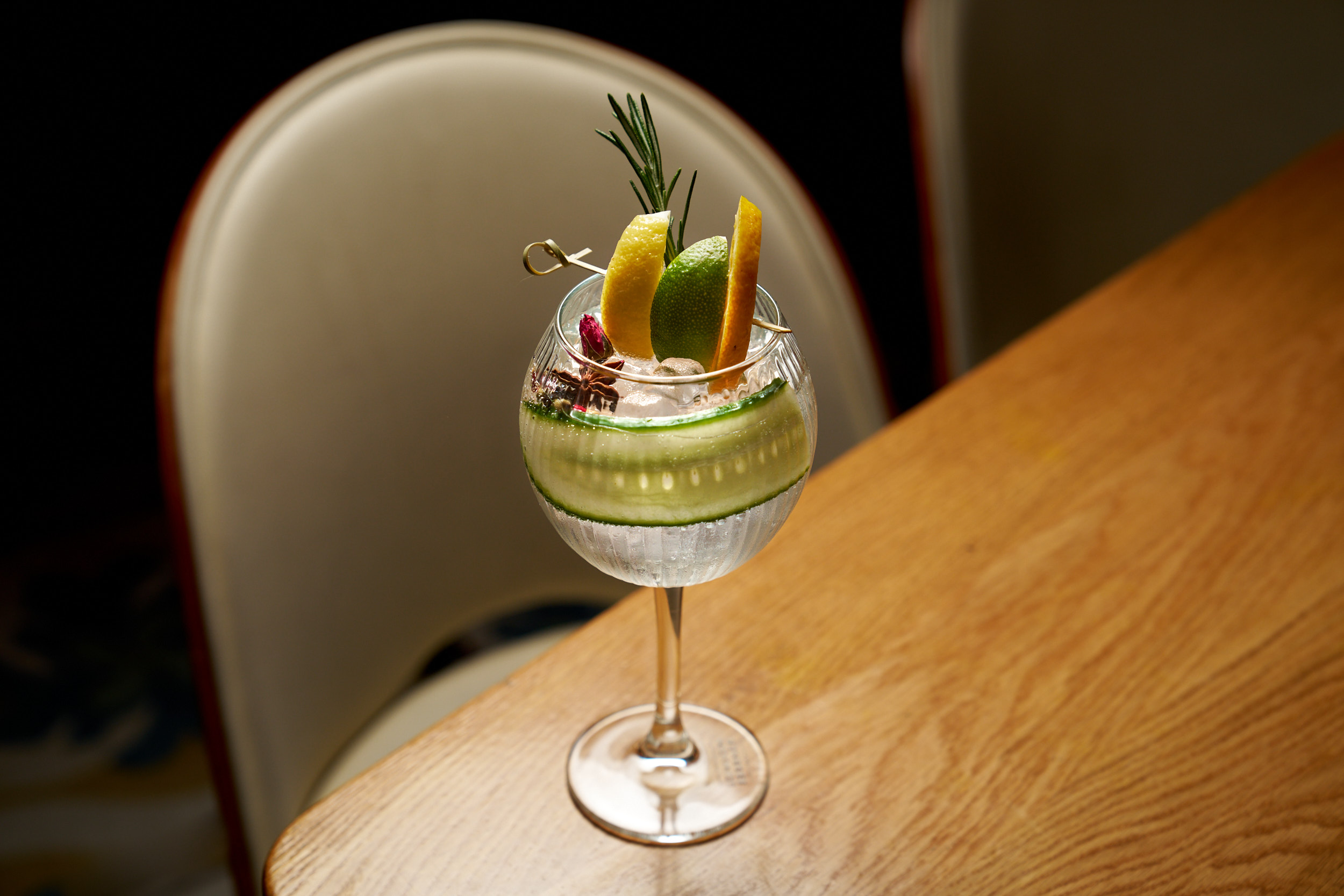 a glass of wine sitting on top of a wooden table