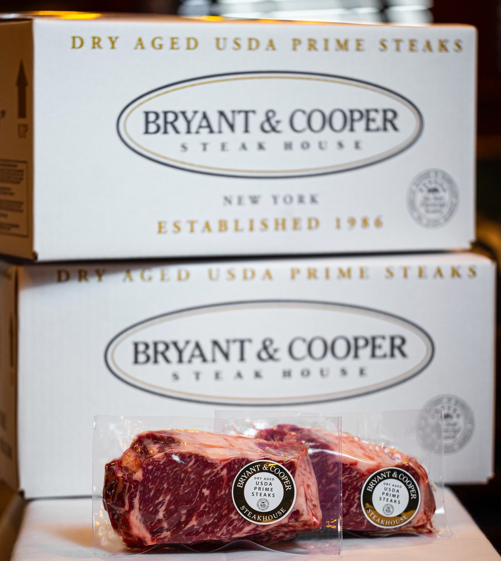 a box of steaks with steaks in front