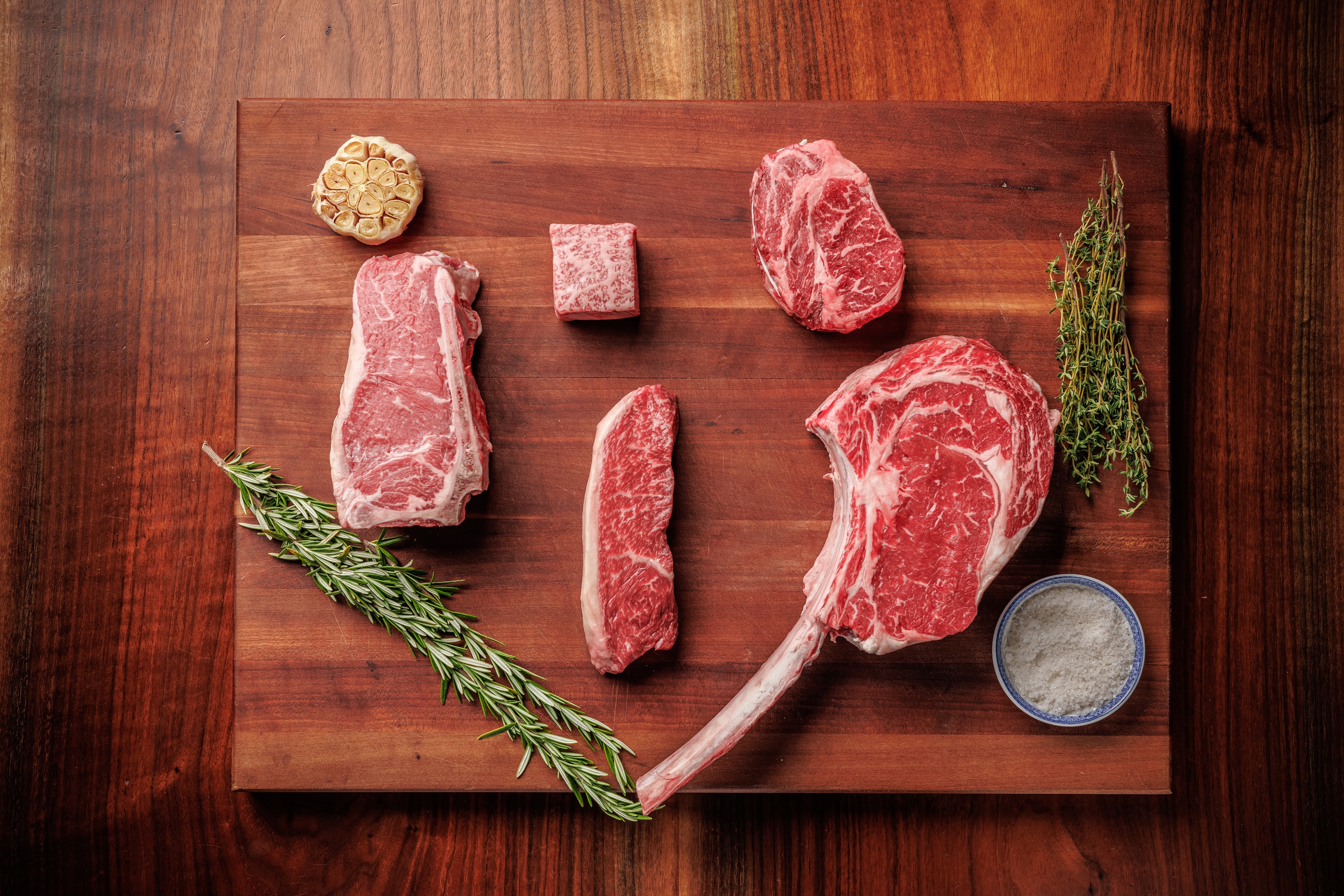 a cutting board with meat and spices