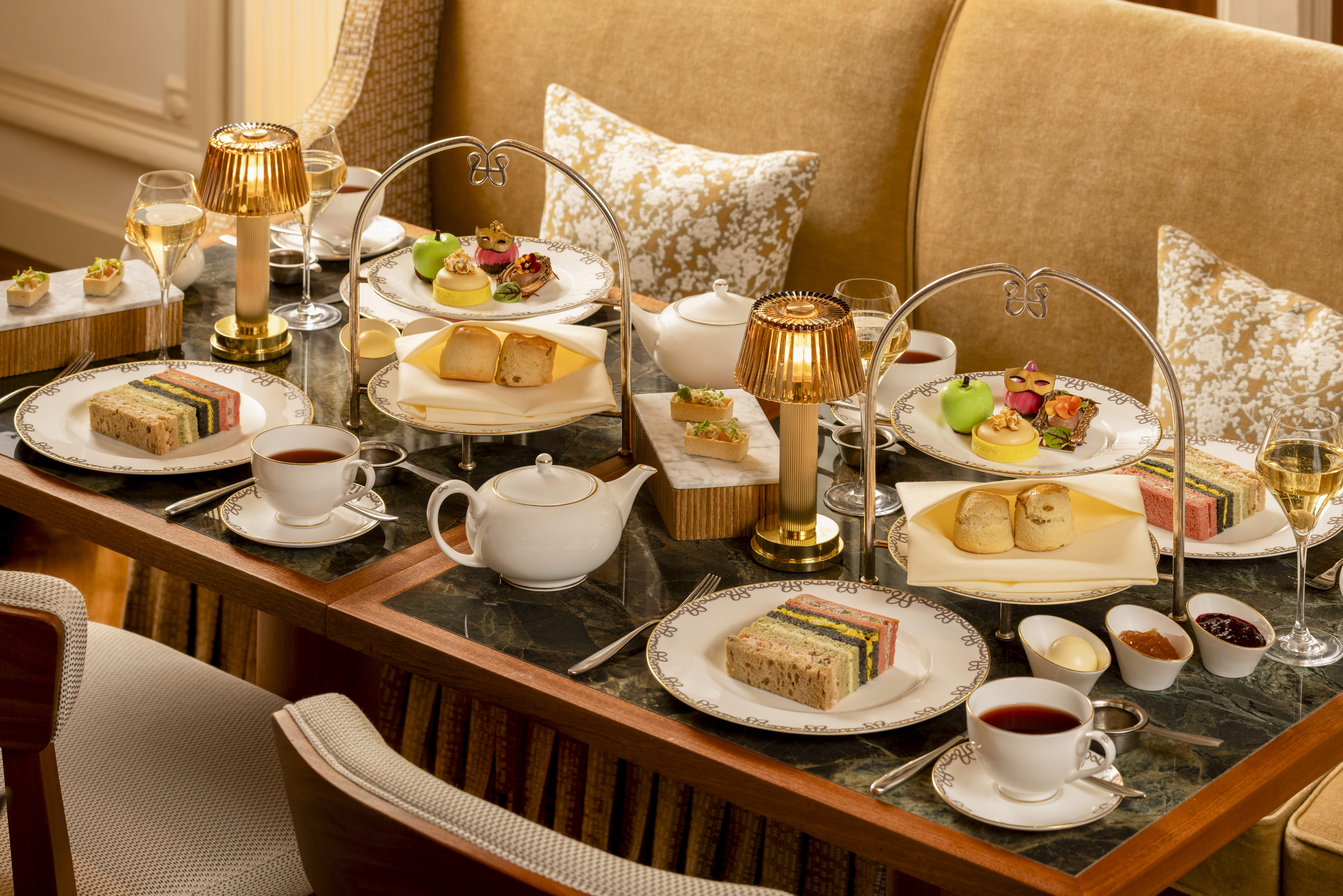 a table with plates of food and teapots