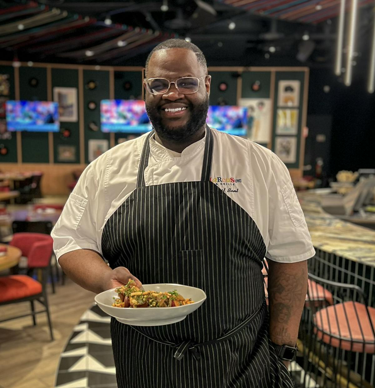 a man sitting at a table with a plate of food