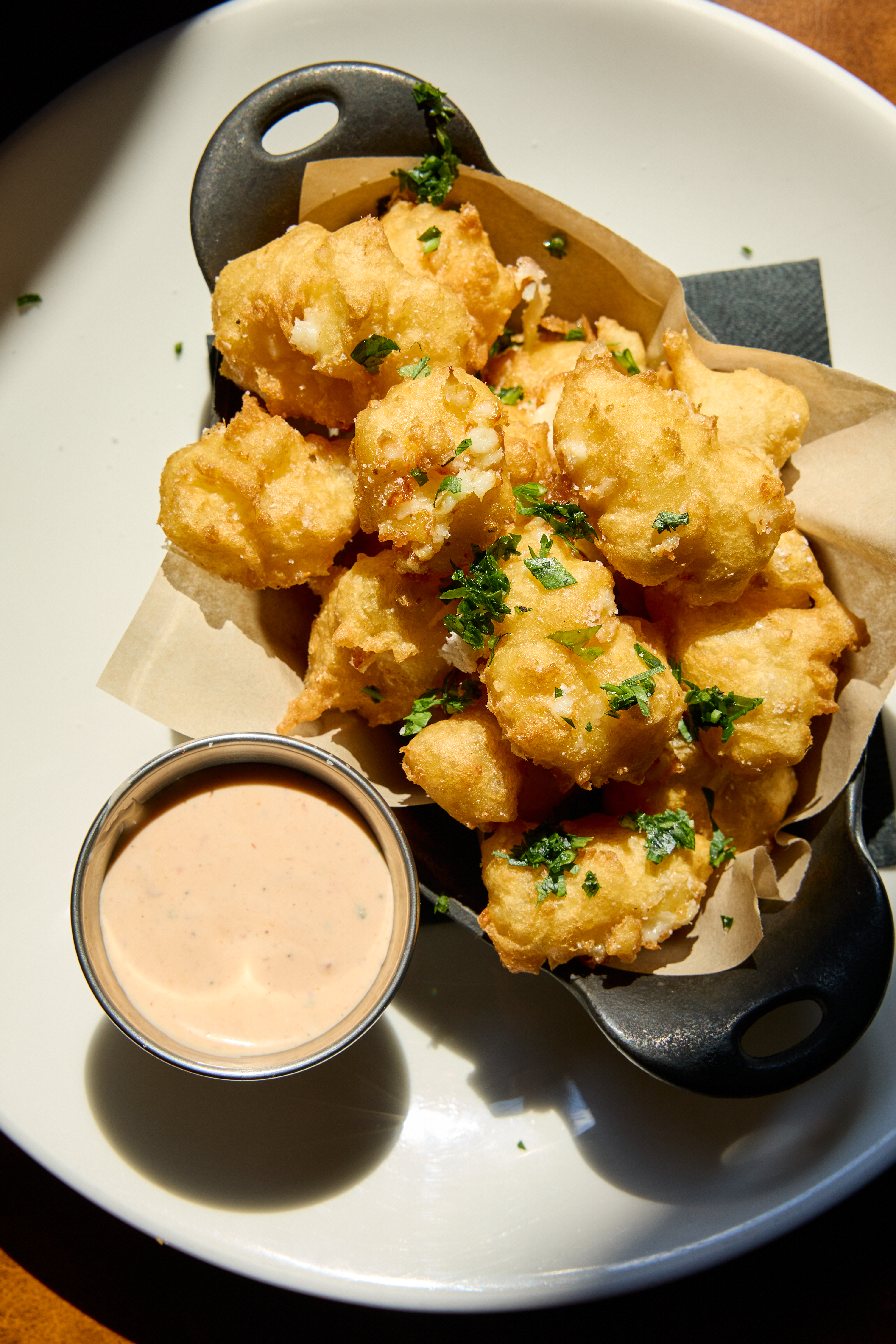 a bowl of fried food with sauce