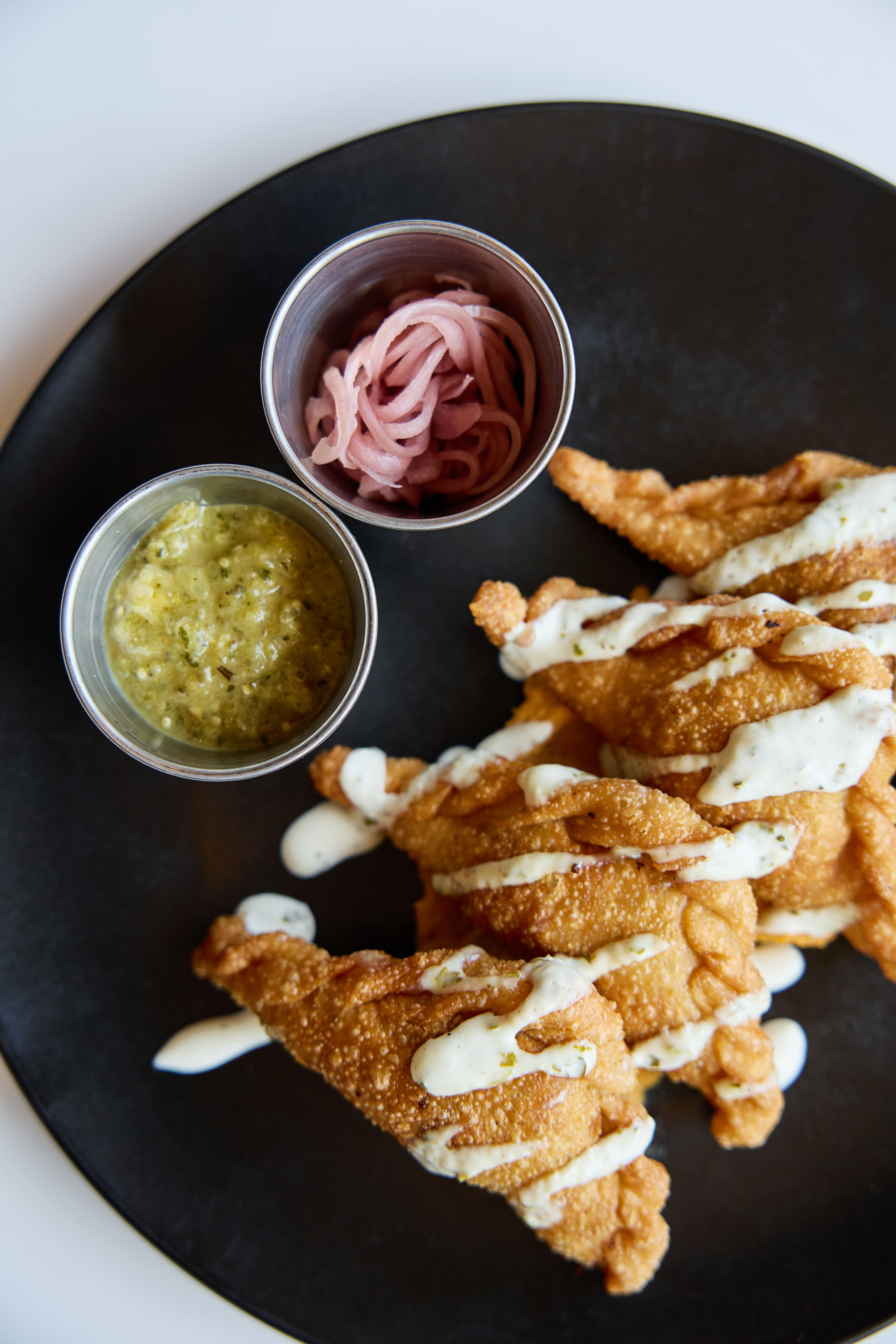 food on a plate with sauces