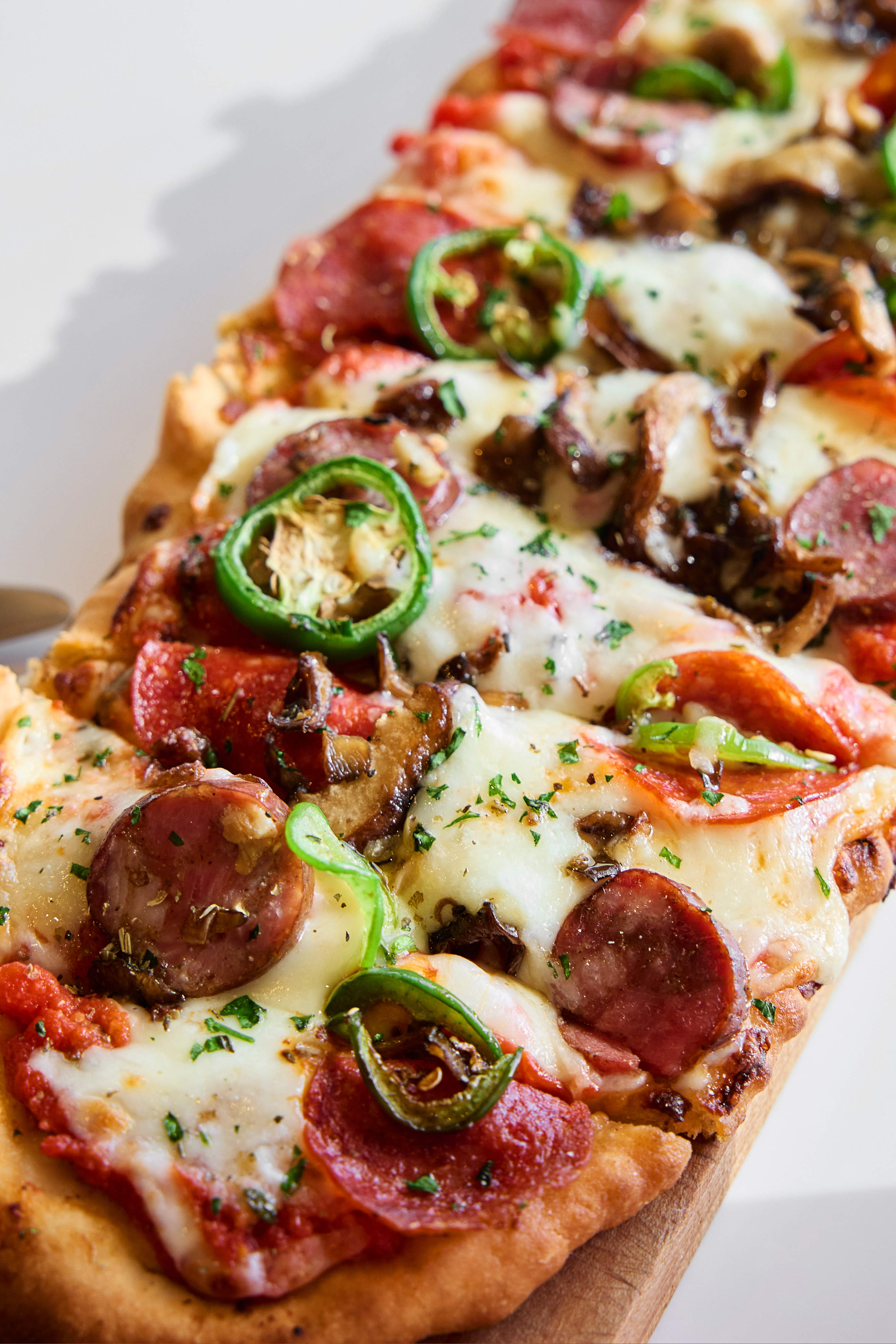 a pizza with pepperoni and jalapenos