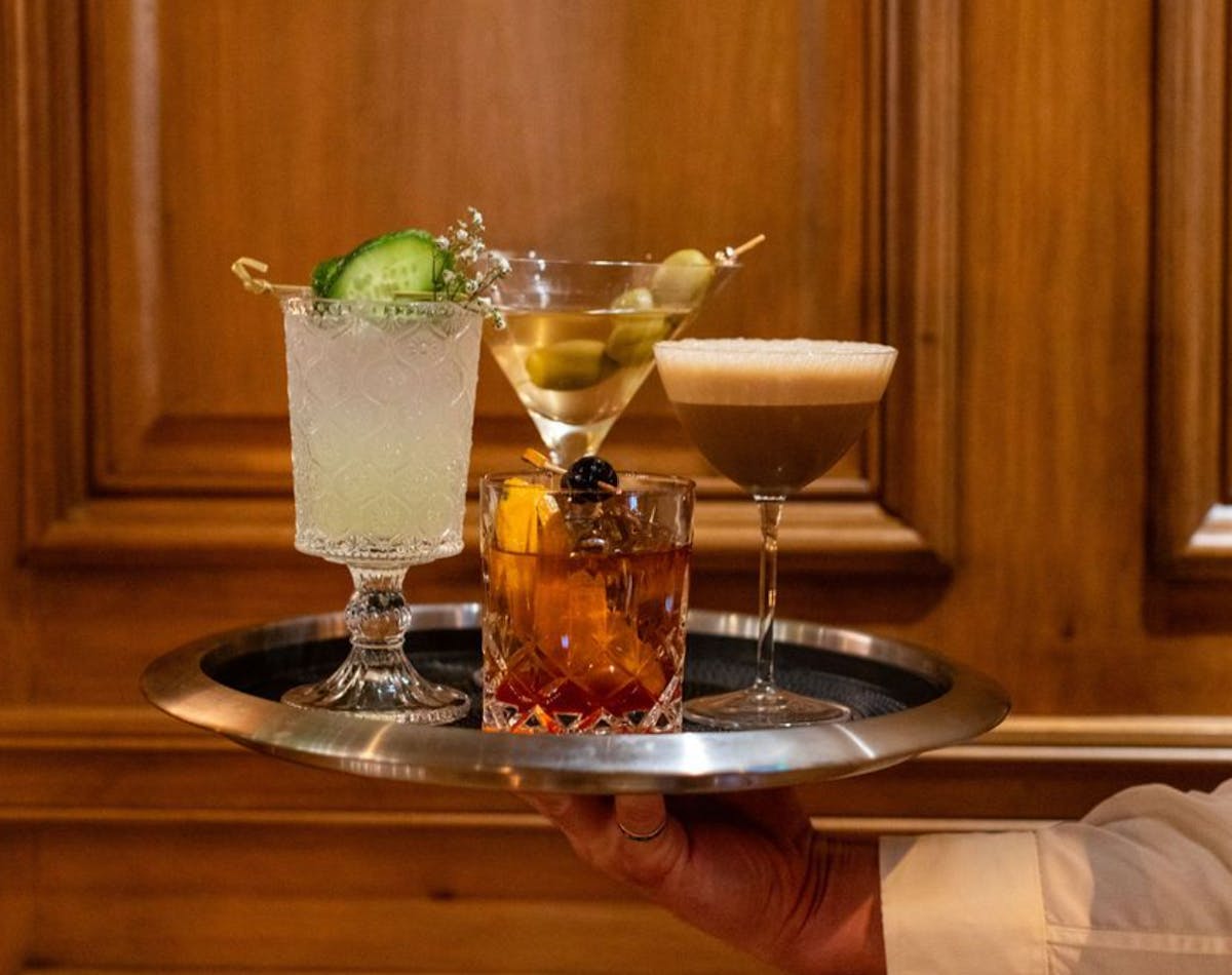 a glass of wine sitting on top of a wooden table