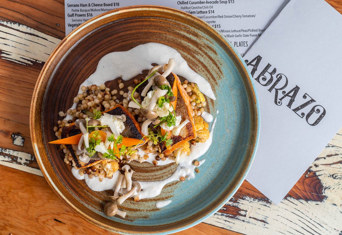 a plate of food sitting on top of a wooden table