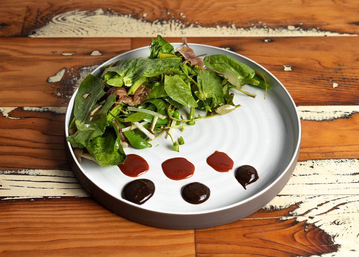 a plate of food sitting on top of a wooden table