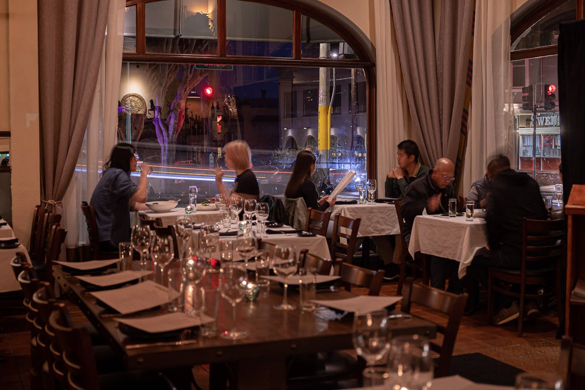 a group of people sitting at a table in a restaurant