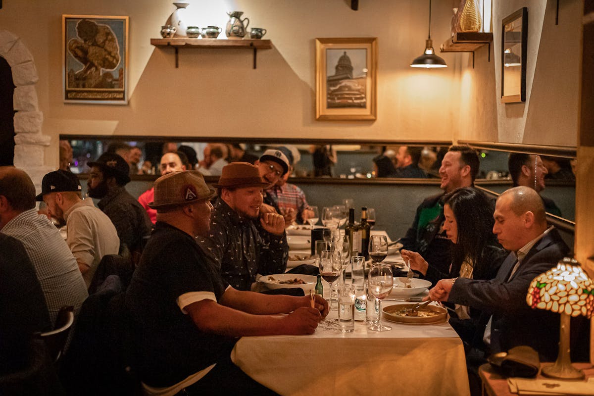 a group of people sitting at a table with wine glasses