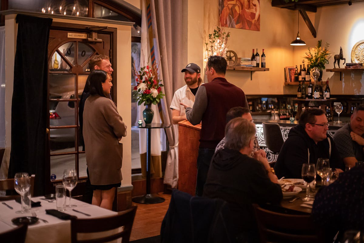 a group of people sitting at a table with wine glasses