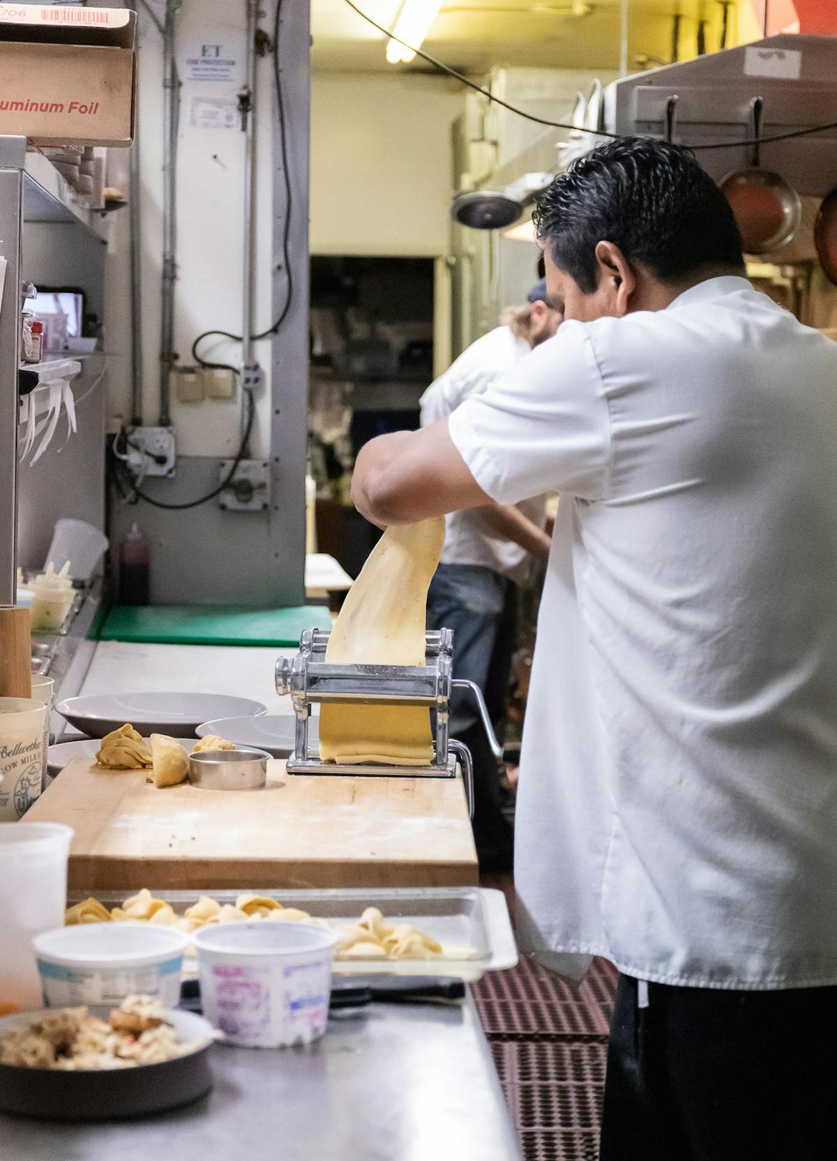 a man standing in a kitchen preparing food