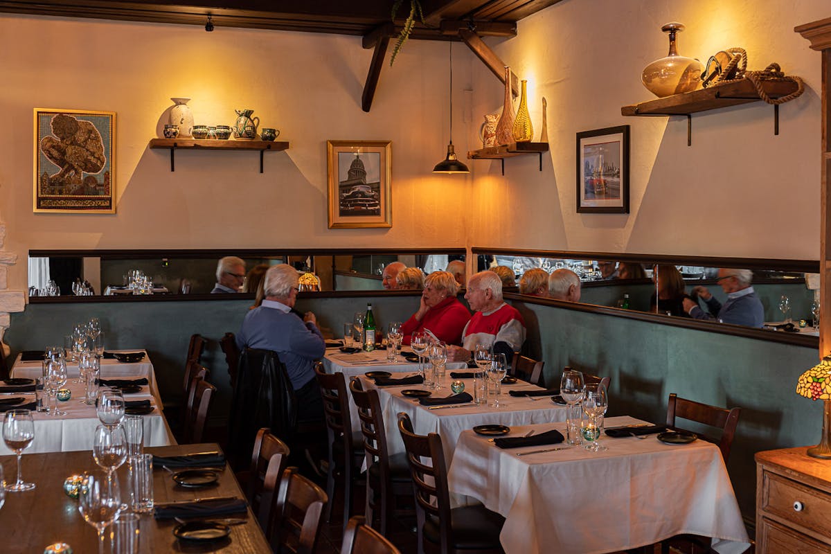 a group of people sitting at a table in a restaurant