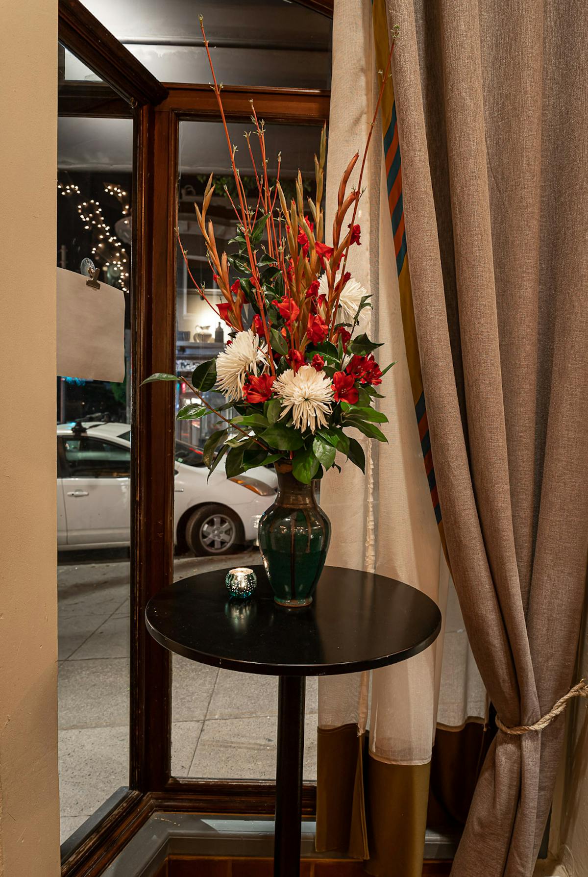 a room filled with furniture and vase of flowers