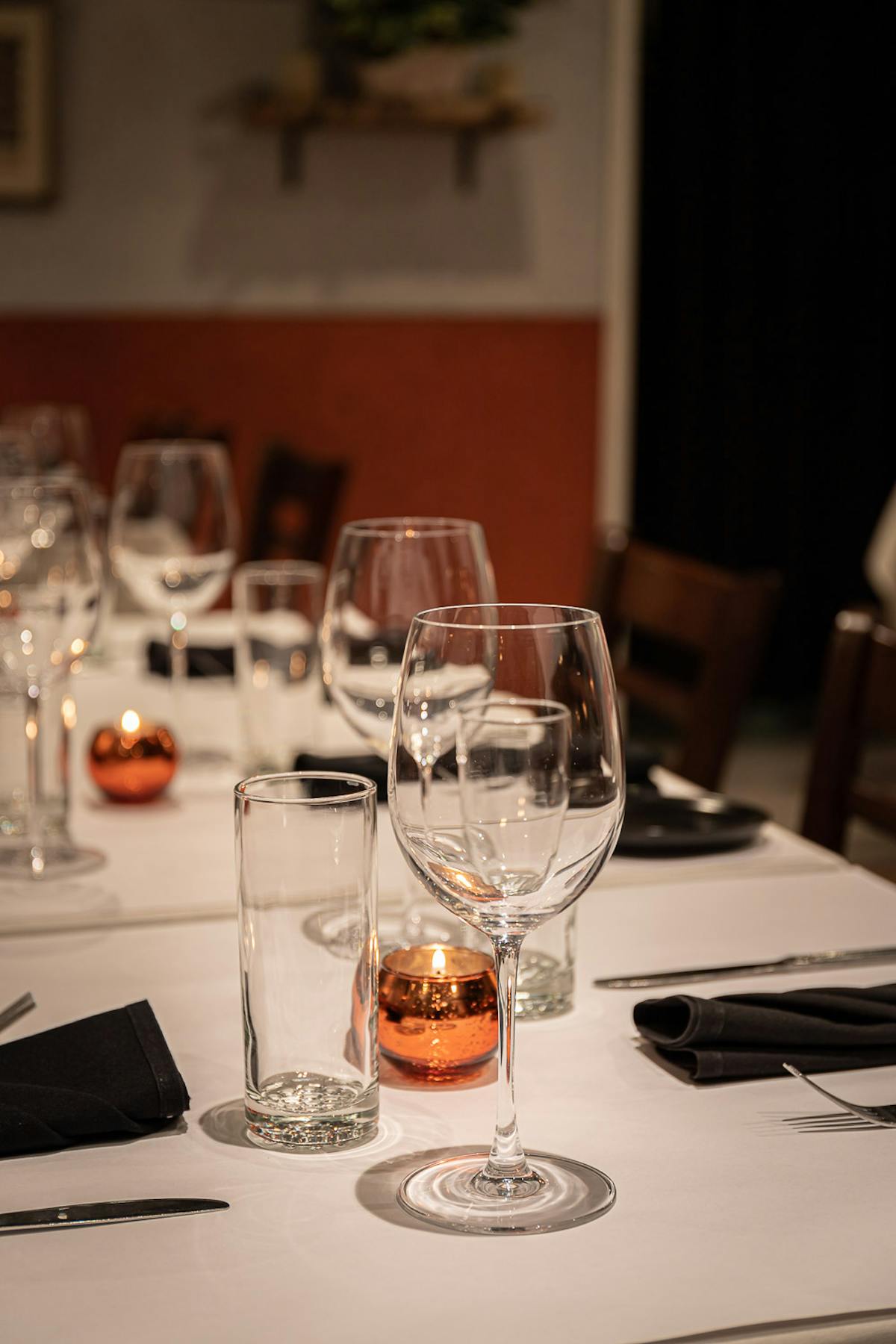 a group of people sitting at a table with wine glasses