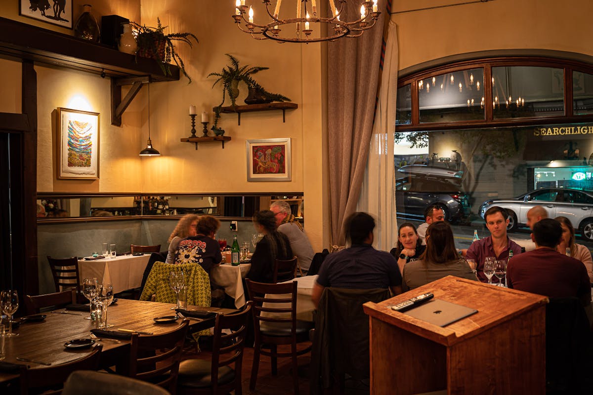a group of people sitting at a table in a restaurant