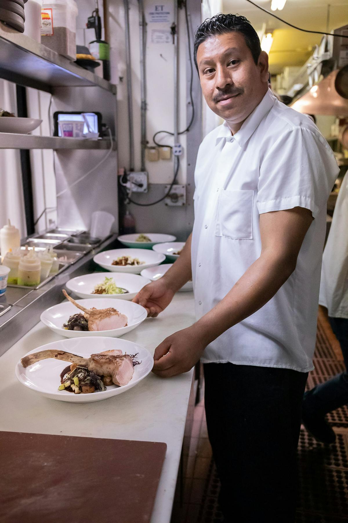 a person standing in a kitchen preparing food
