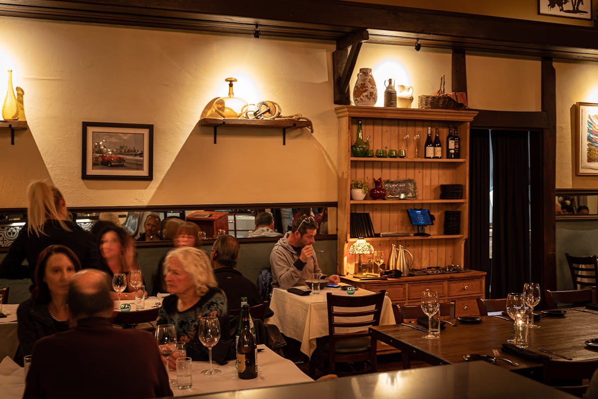 a group of people sitting at a table in a restaurant