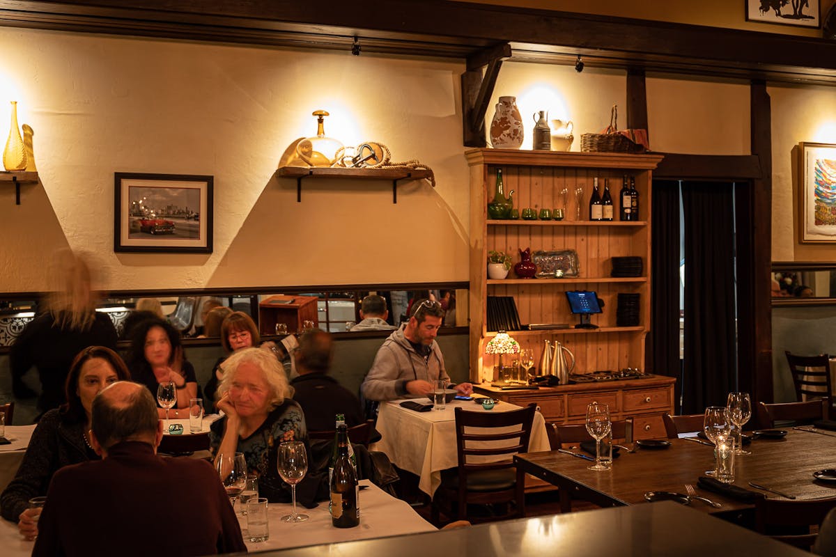 a group of people sitting at a table in a restaurant