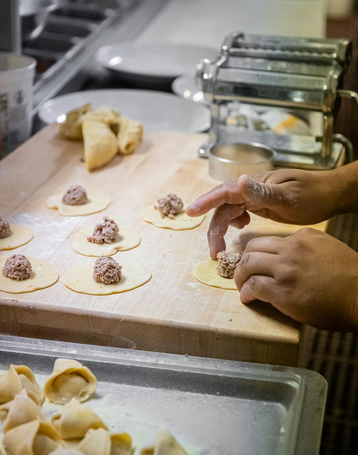 a person cooking food on a tray
