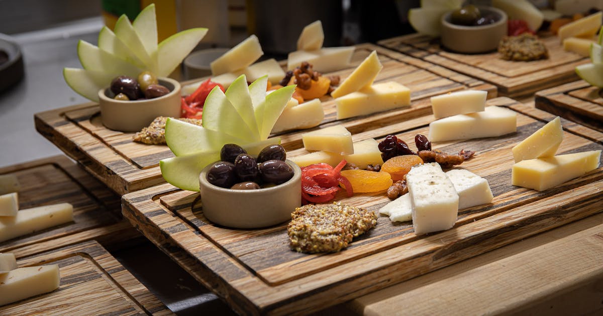 a table topped with plates of food on a wooden cutting board