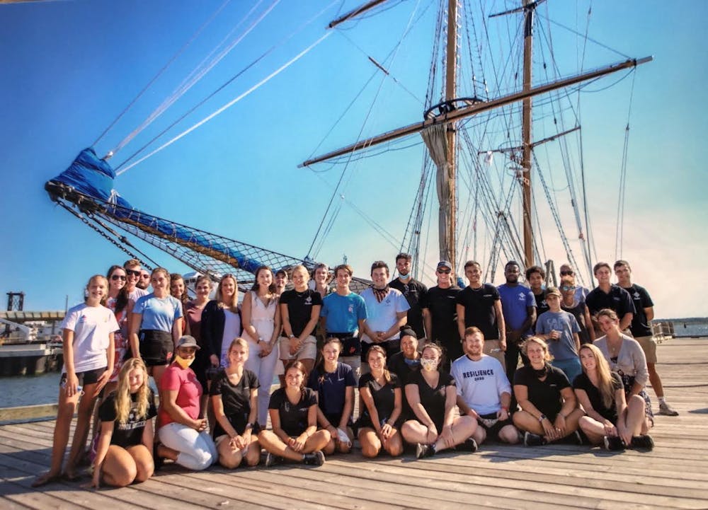 a group of people on a boat posing for the camera