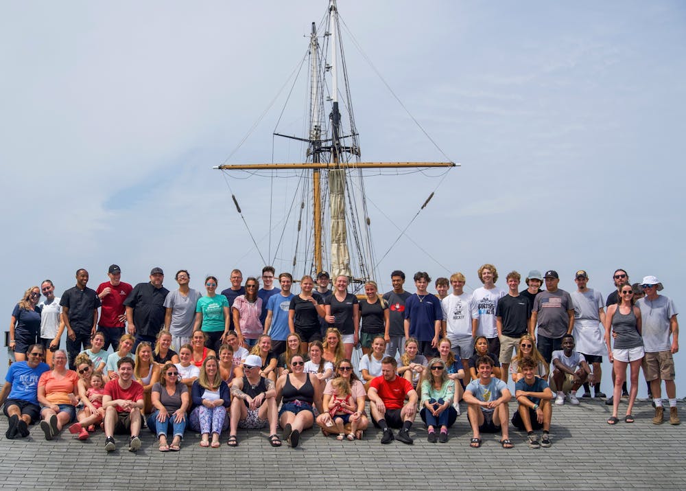 a group of people on a boat in front of a crowd