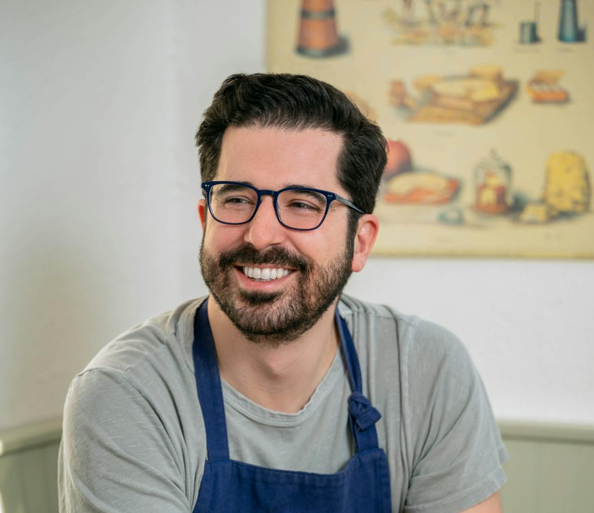 a man in glasses looking at the camera