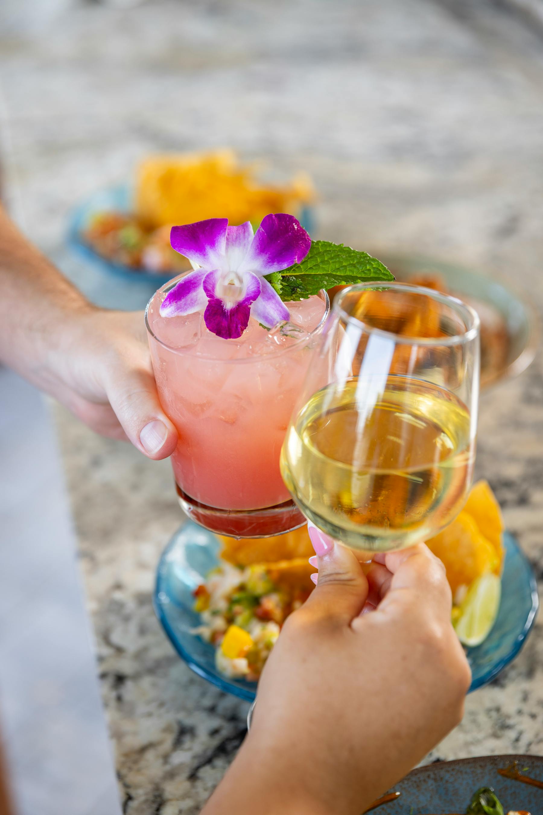 a couple of hands holding drinks