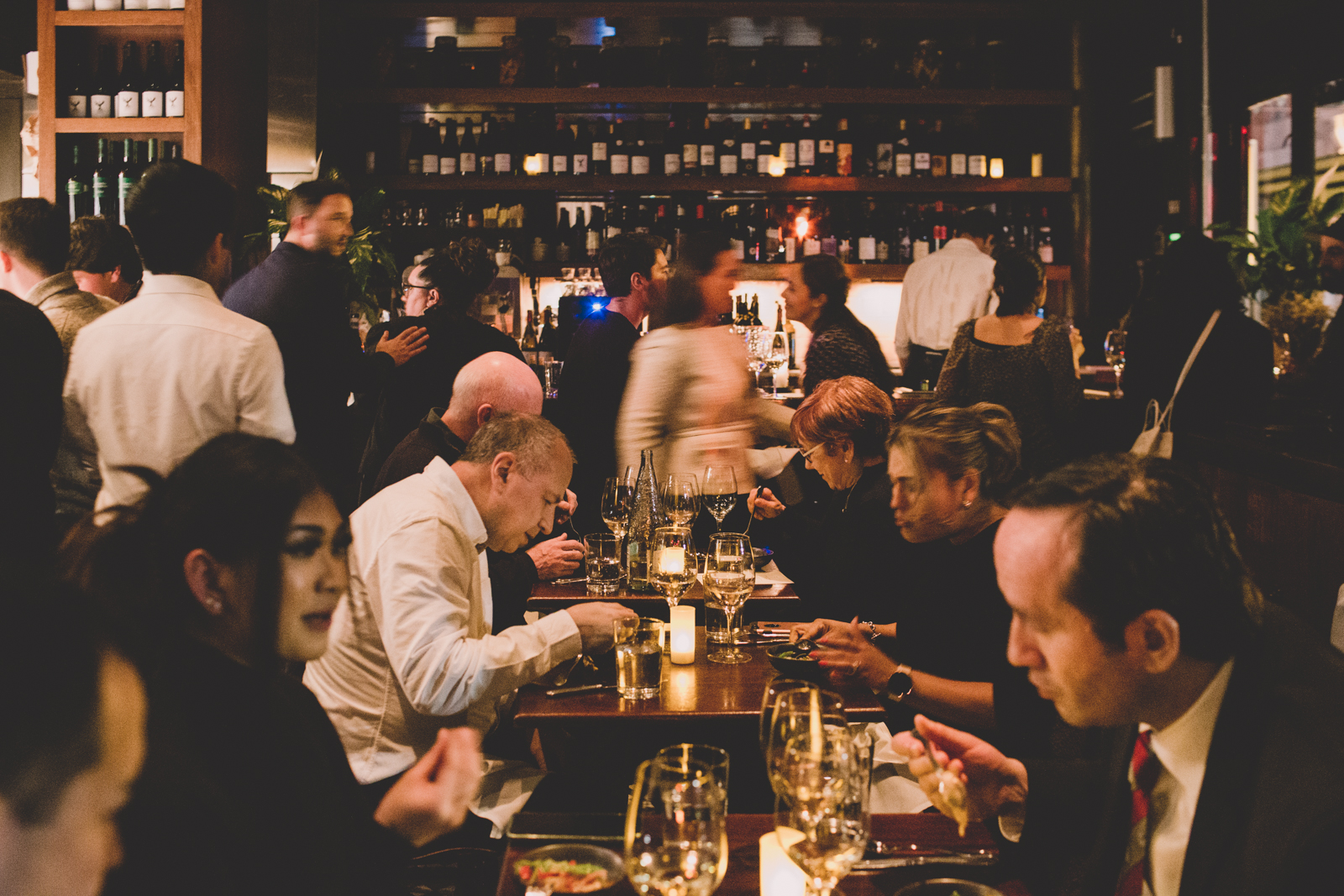 a group of people sitting at a table in a restaurant
