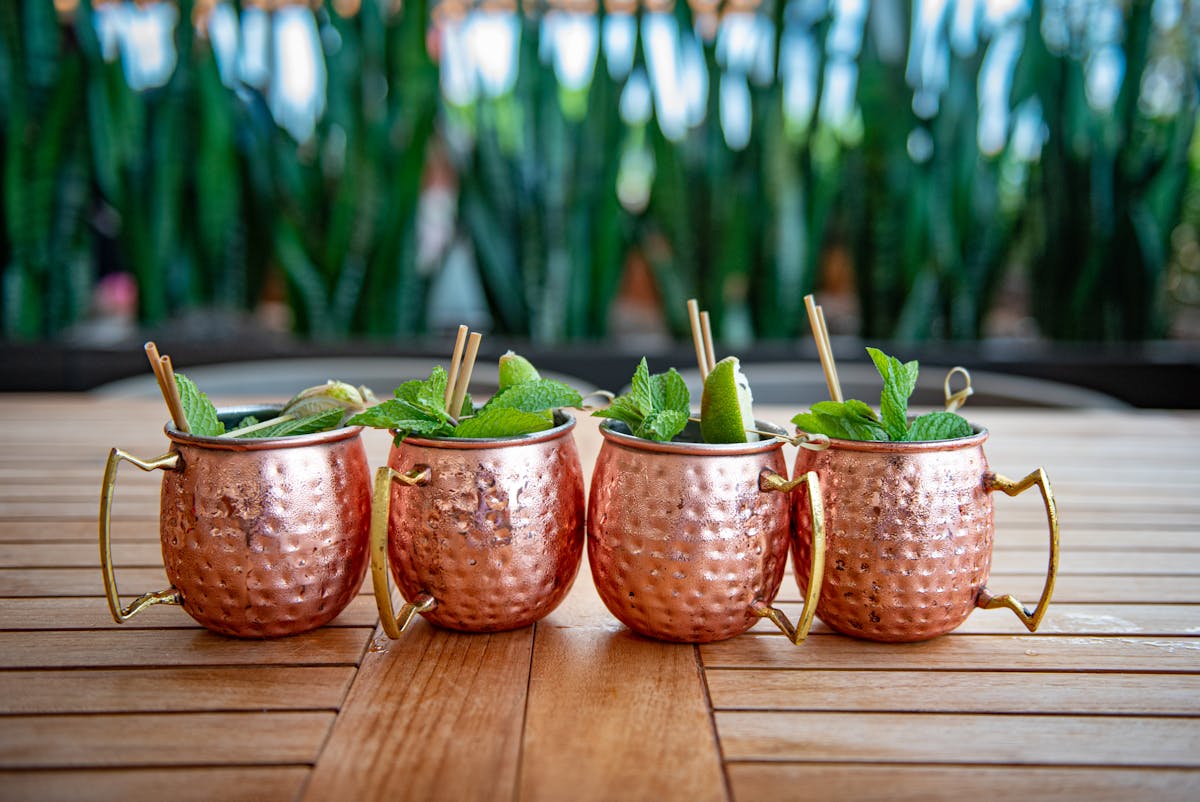 a group of oranges sitting on top of a wooden table