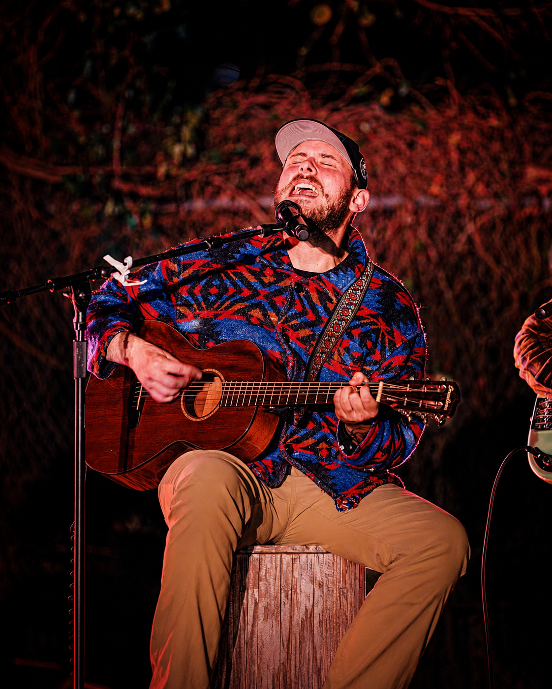 a man playing guitar and singing