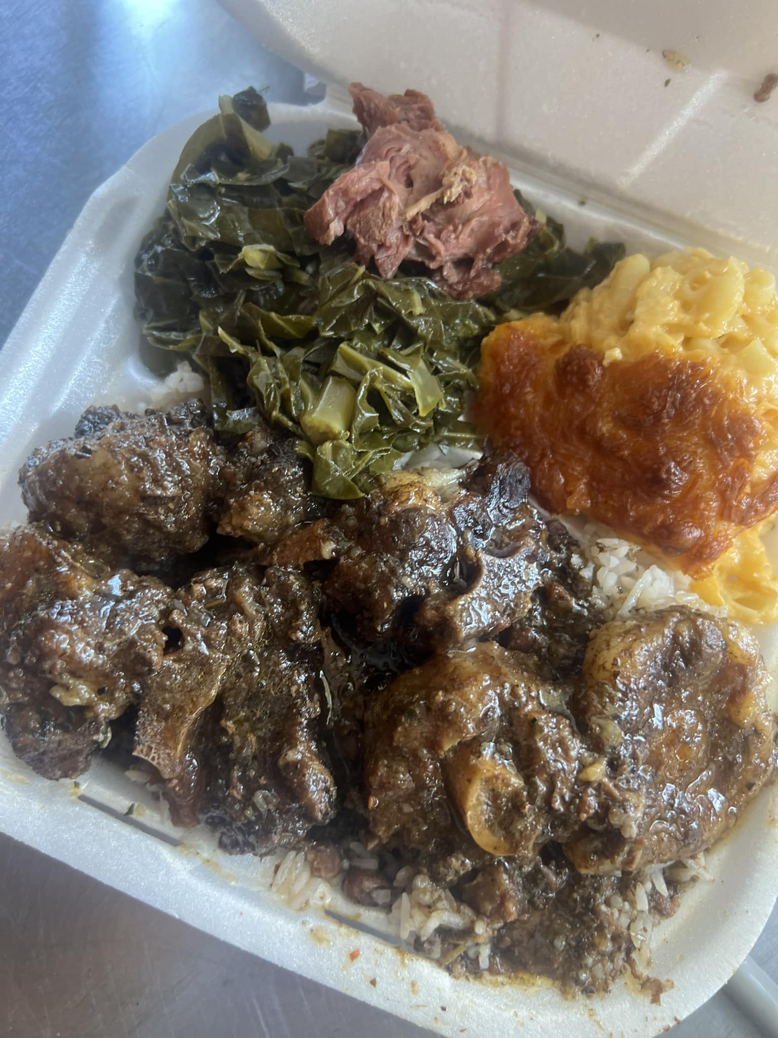 a plastic container filled with meat and vegetables