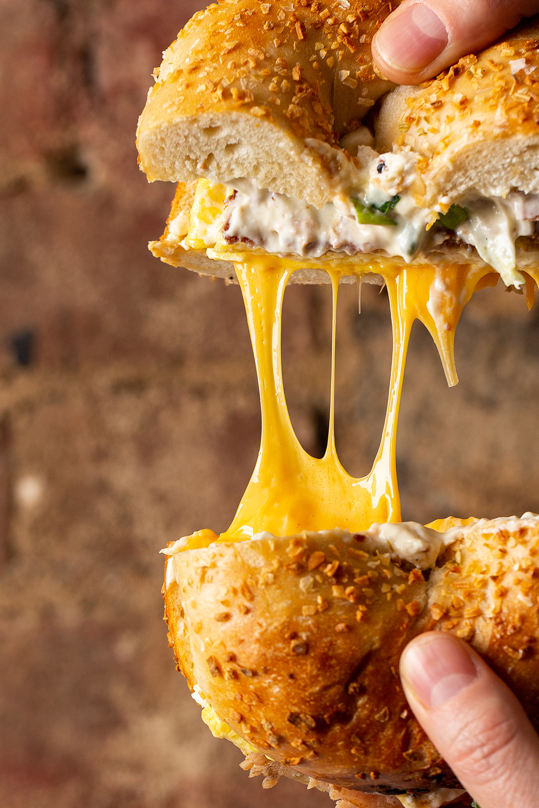 a hand holding a half eaten piece of food