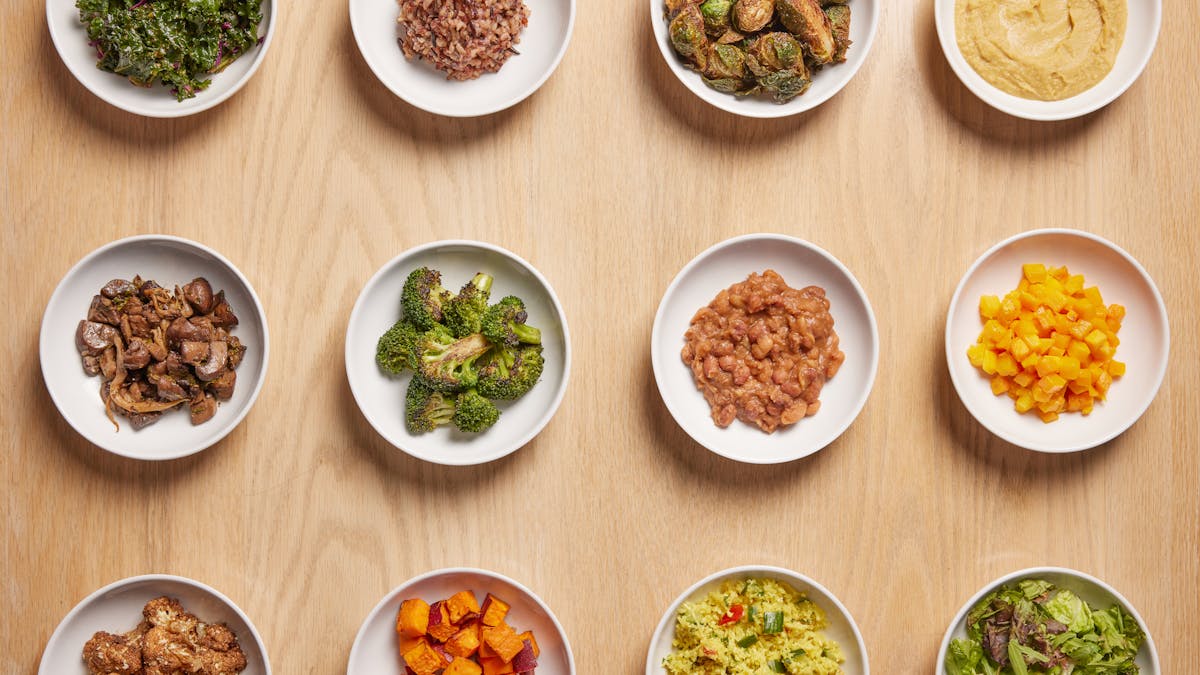 a collection of side dishes on a wooden table