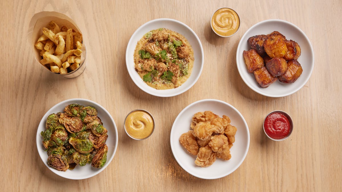a collection of side dishes on a wooden table
