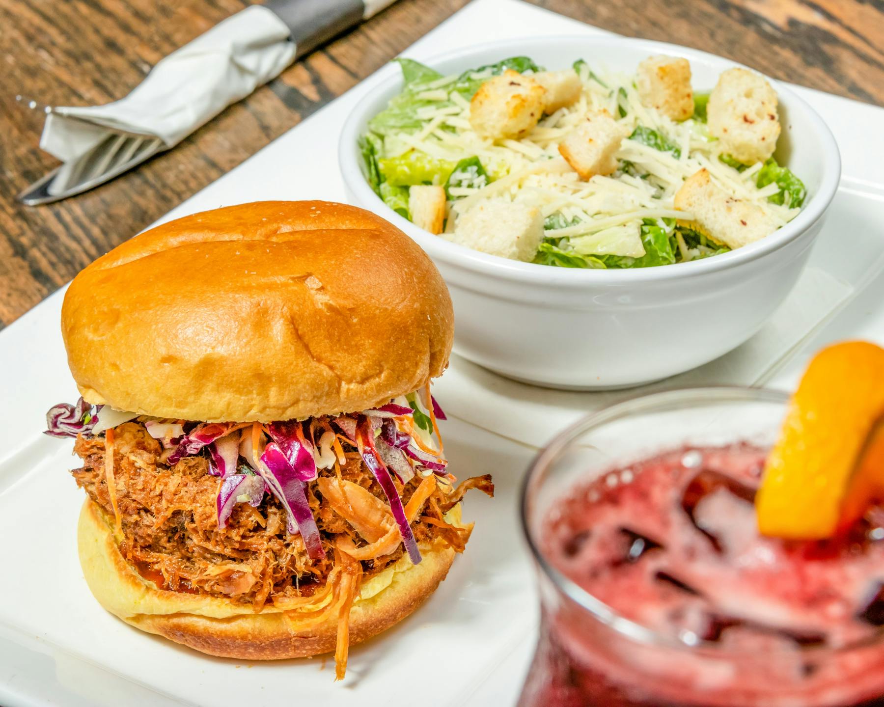 pulled pork with Caesar salad and cocktail