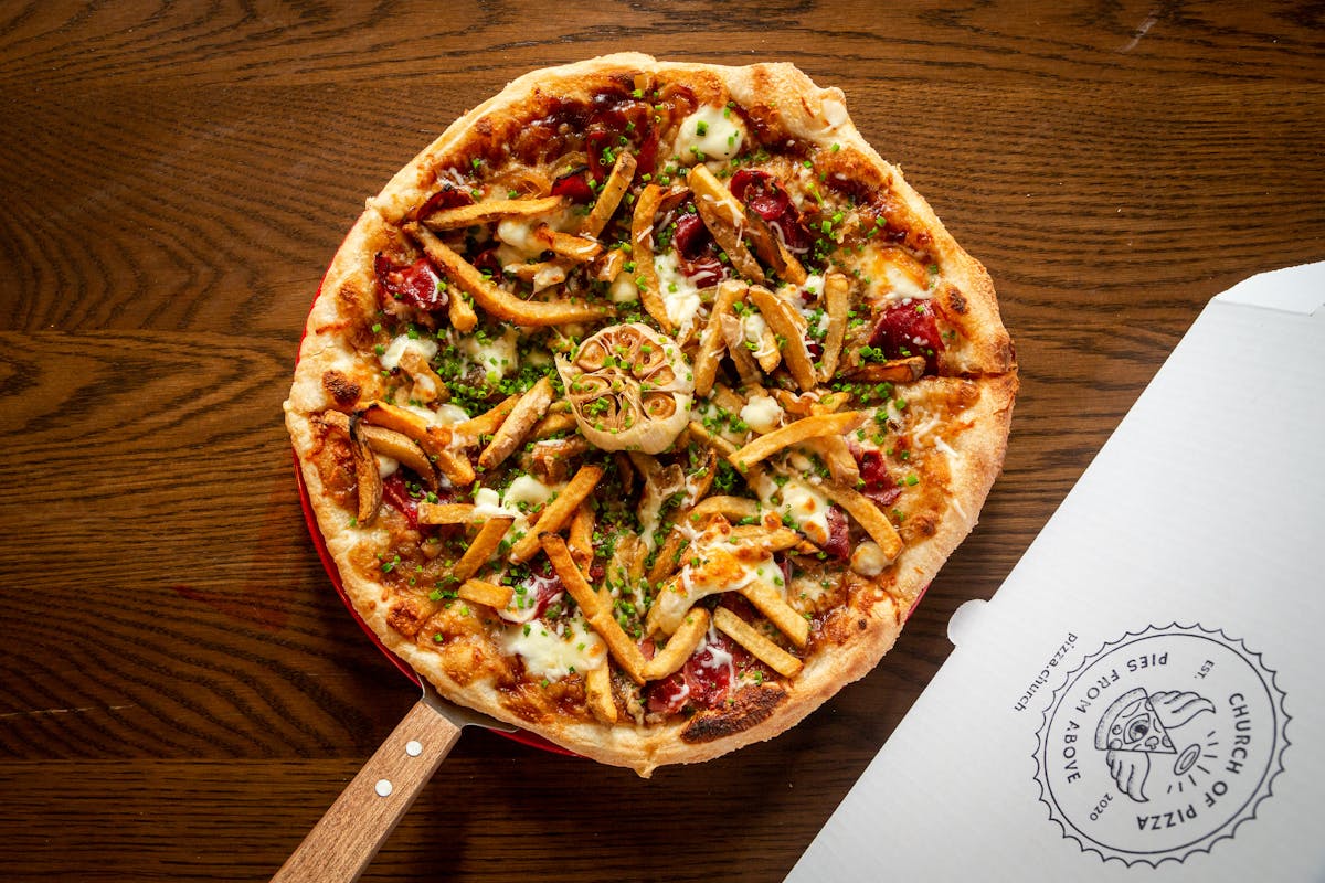 a pizza sitting on top of a wooden cutting board