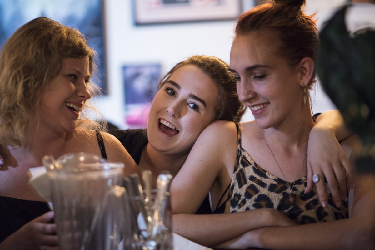 Friends leaning on each other