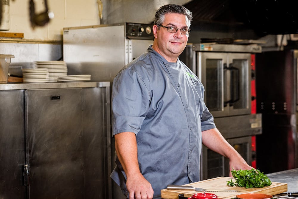 a man standing in a kitchen preparing food