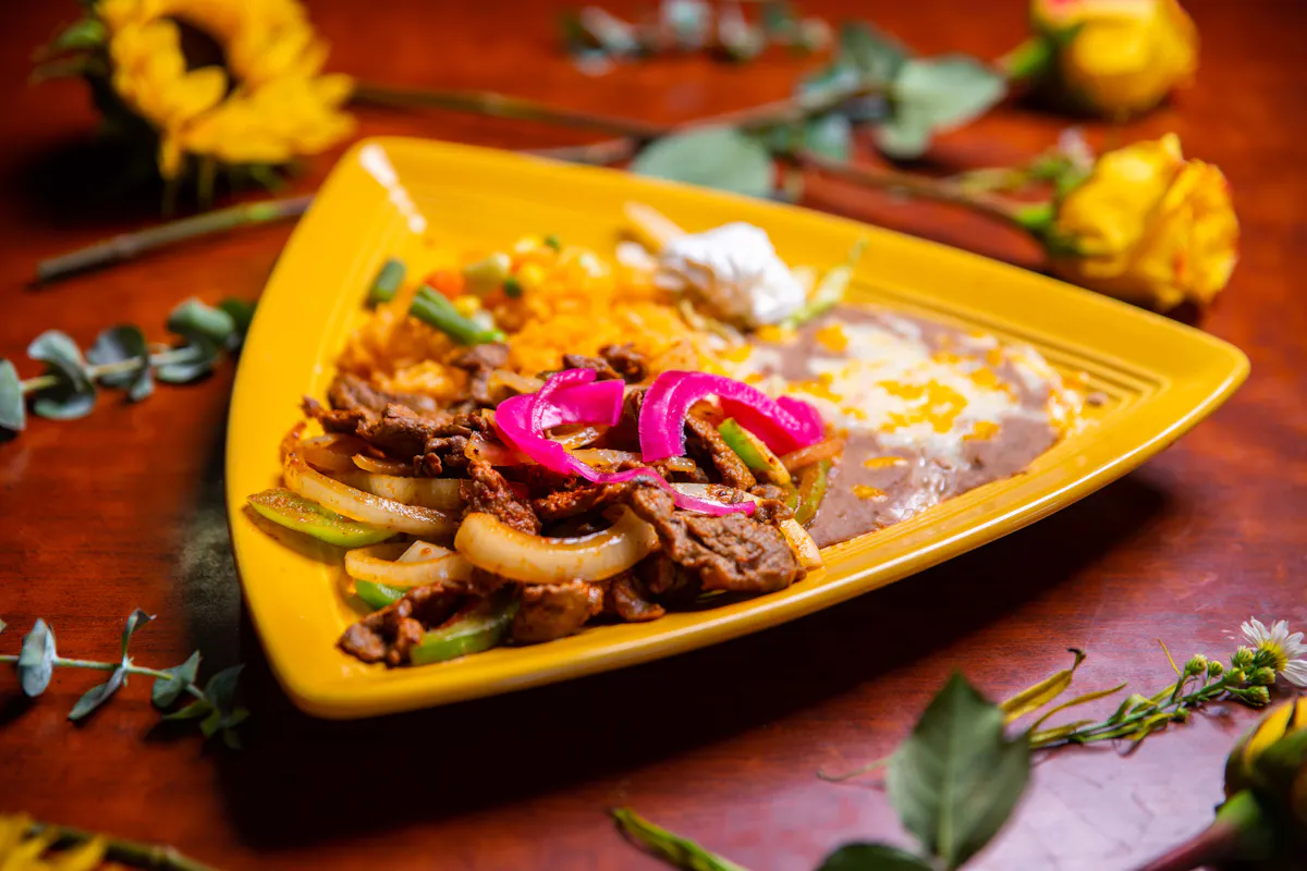 a plate of food sitting on top of a wooden table