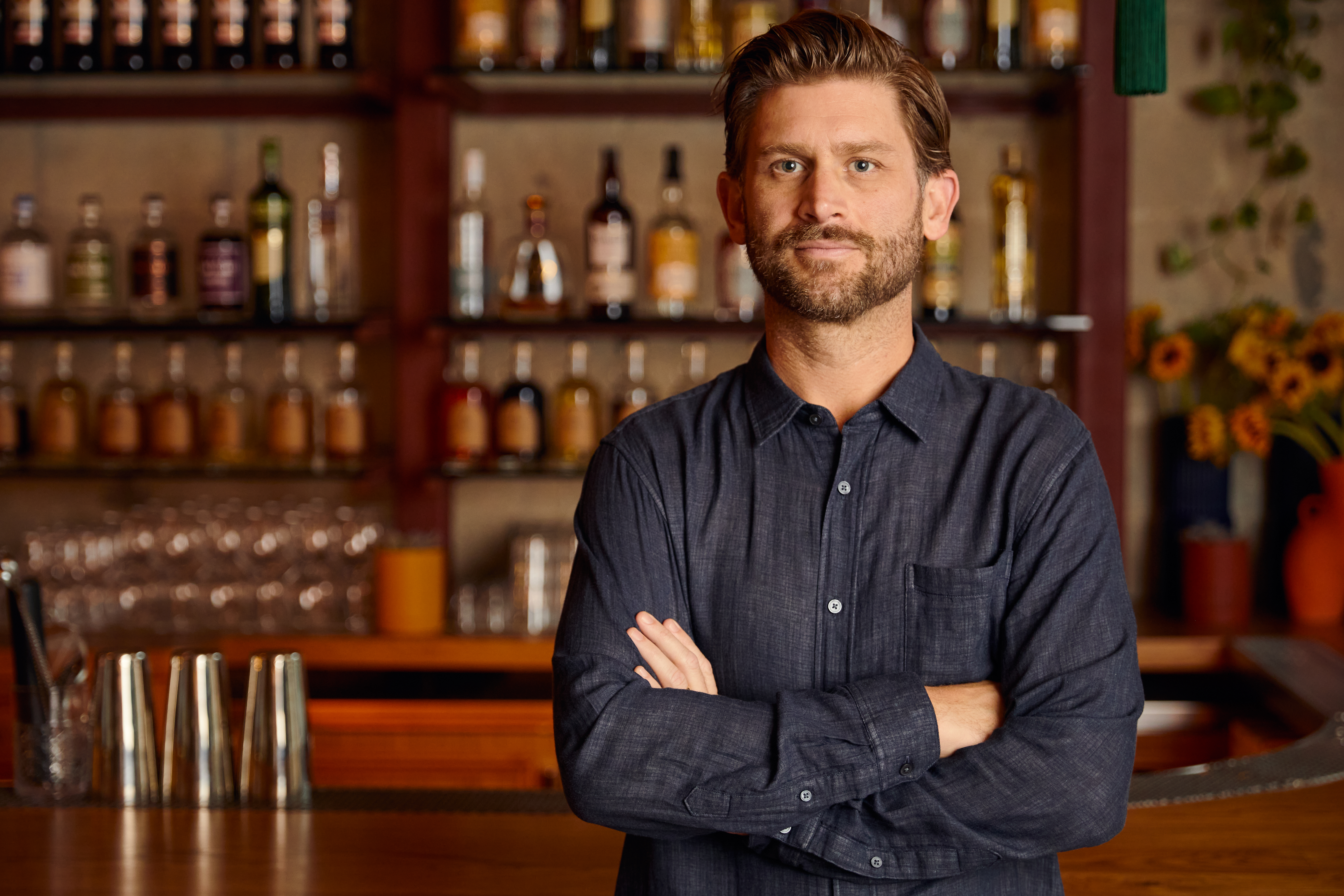 a man standing in front of a bar
