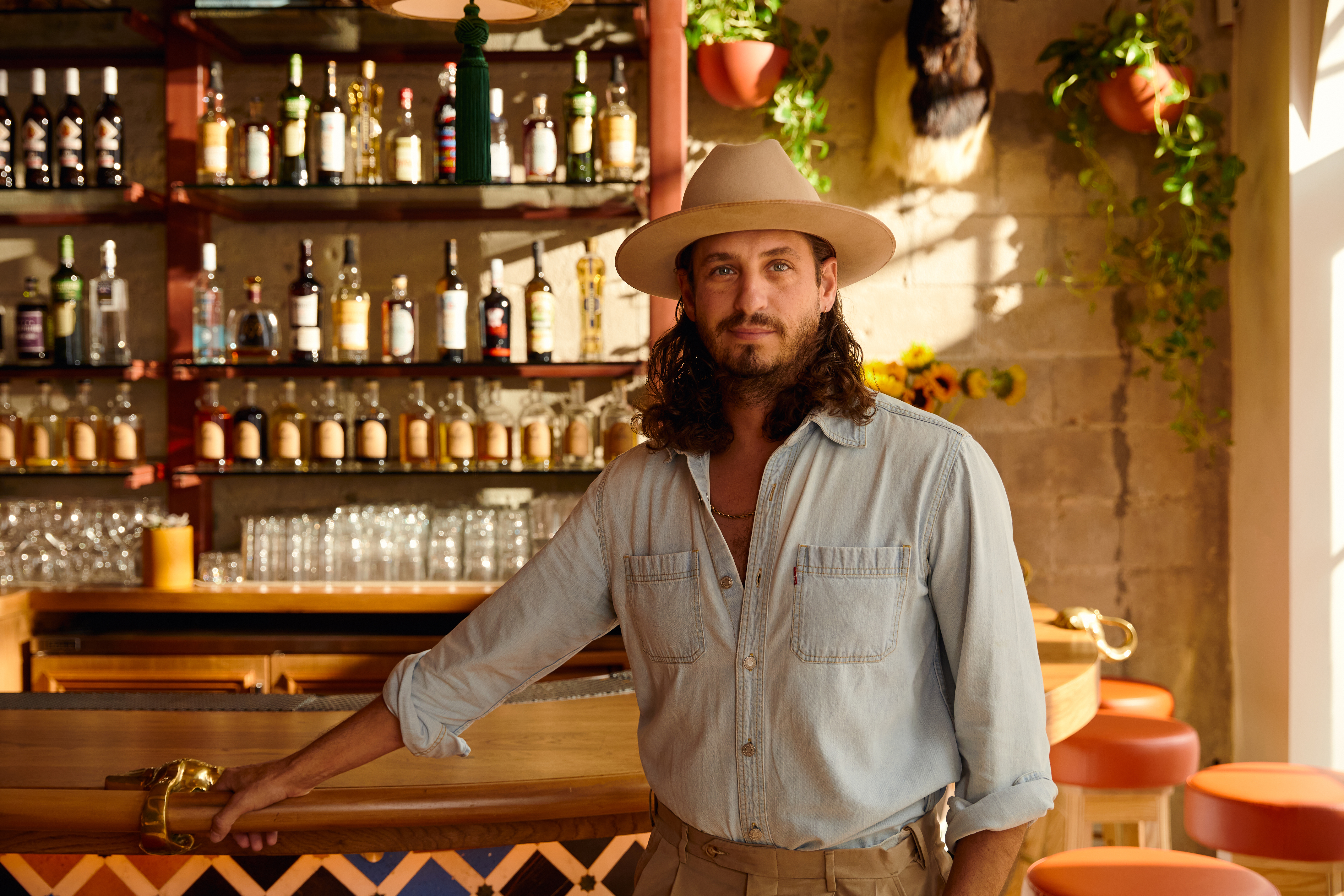 a man standing in front of a bar