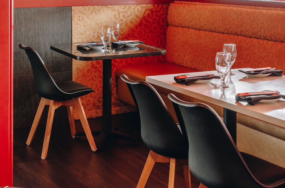 a set of dining tables topped with empty wine glasses
