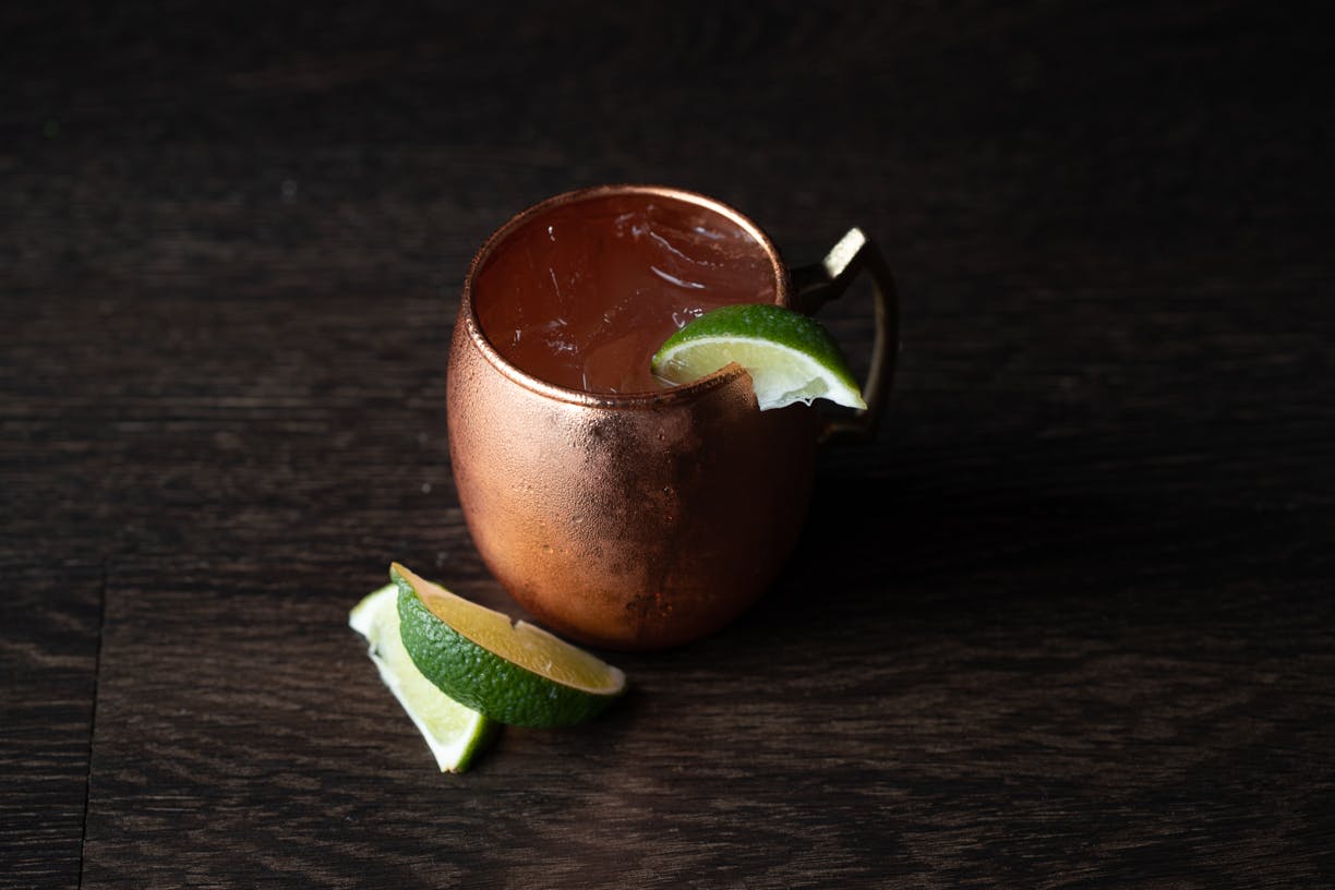 a cup filled with water sitting on a black wooden table
