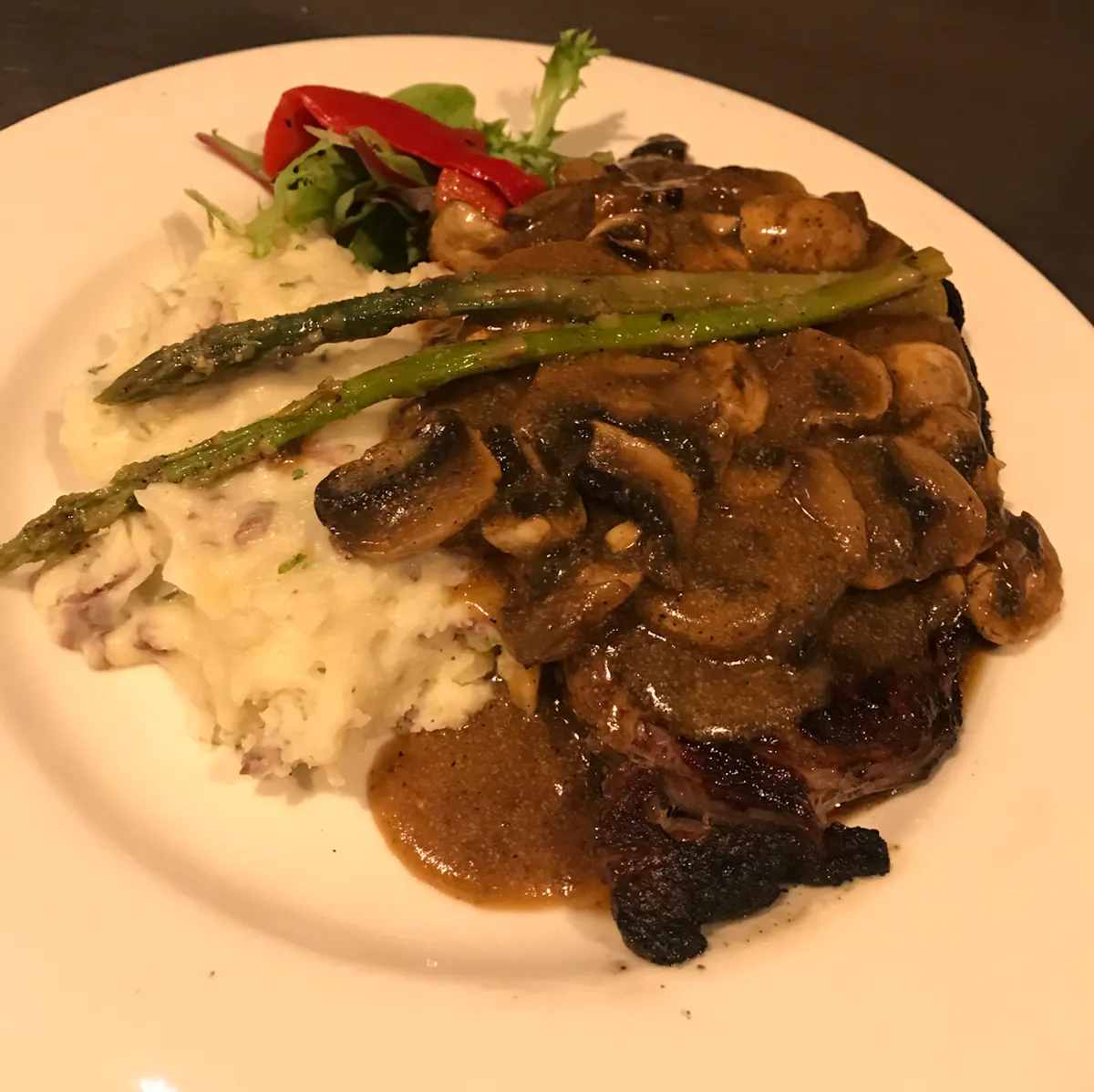 a white plate topped with meat and vegetables