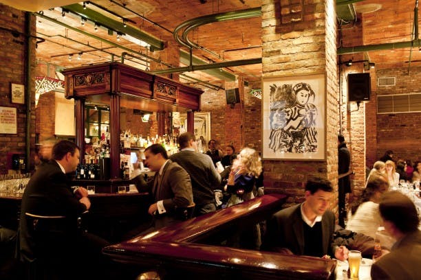 a group of people sitting at a table in a restaurant
